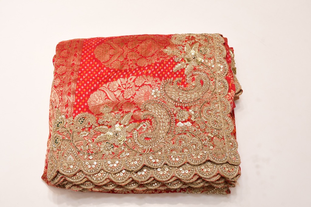 Folded red bridal saree with gold-tone scalloped border — product 06